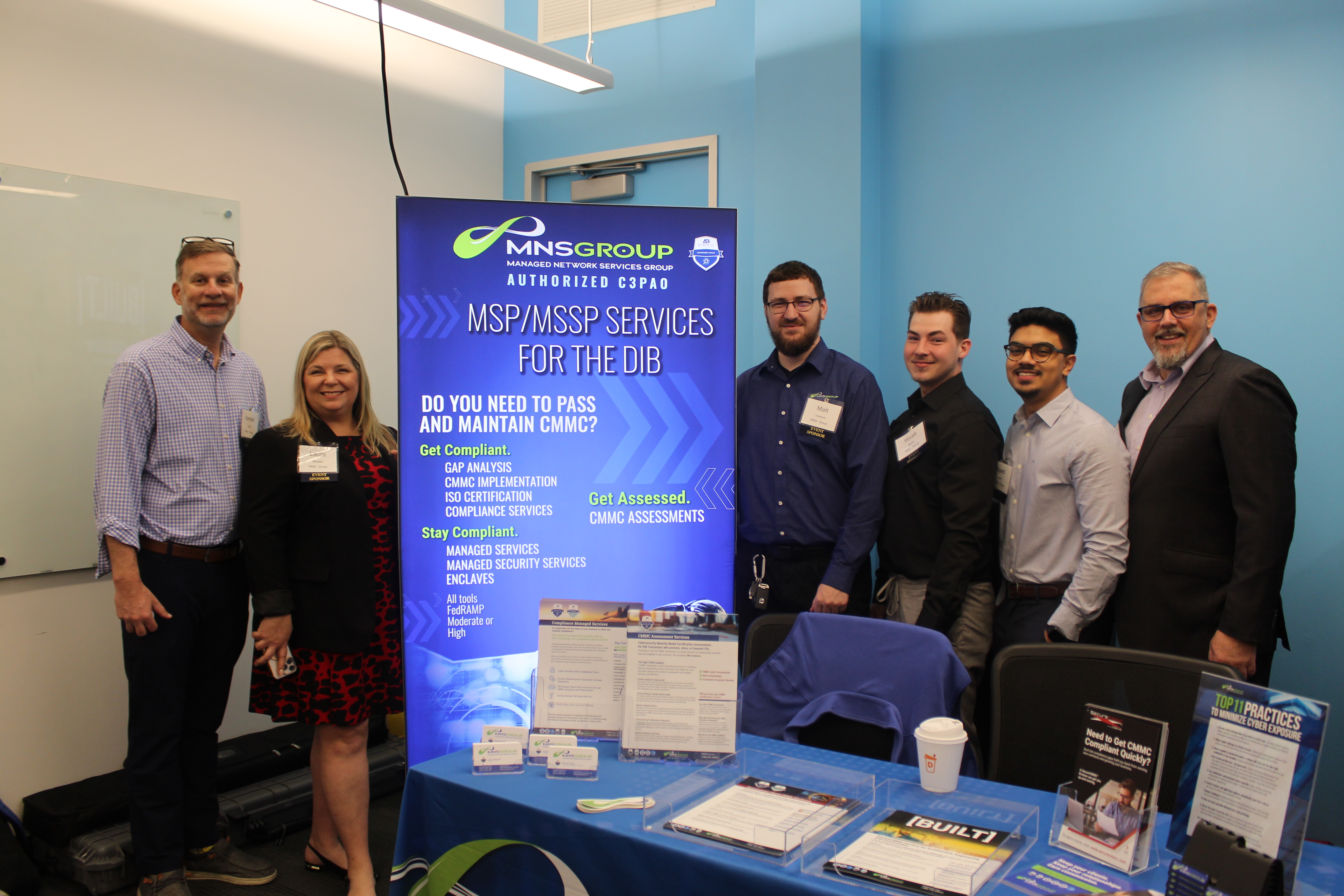 Cybersecurity professionals and government contractors networking at the 2025 CMMC Summit, discussing CMMC 2.0 compliance, assessment readiness, and controlled unclassified information (CUI) protection.